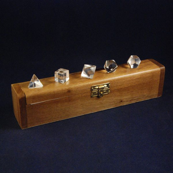 Set of Platonic solids made of quartz in a wooden box